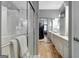 Modern main bathroom with a glass shower, double sinks, white cabinetry, and walk-in closet at 221 Collierstown Way, Peachtree City, GA 30269