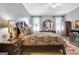 Comfortable main bedroom with a large bed, dresser, sitting area, and ensuite bath at 221 Collierstown Way, Peachtree City, GA 30269