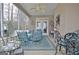 Inviting screened porch featuring a ceiling fan, seating, and tranquil backyard views at 221 Collierstown Way, Peachtree City, GA 30269