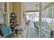 Cozy screened porch with charming decor, furniture, and backyard access at 221 Collierstown Way, Peachtree City, GA 30269