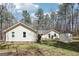 Backyard of charming home featuring a lawn, patio and shed in a wooded setting at 179 Green Valley Rd, Fayetteville, GA 30214