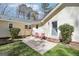 Cozy backyard patio features chairs, lush bushes, and a door leading inside at 179 Green Valley Rd, Fayetteville, GA 30214