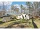 Backyard of charming home featuring a lawn, patio and gazebo in a wooded setting at 179 Green Valley Rd, Fayetteville, GA 30214