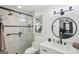 Bright bathroom with glass shower door and modern vanity with a round mirror at 179 Green Valley Rd, Fayetteville, GA 30214