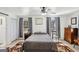 Comfortable bedroom with a ceiling fan, hardwood floors, and natural light from two windows at 179 Green Valley Rd, Fayetteville, GA 30214