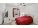 Cozy bedroom with a red comforter, a window with curtains, a tv, and a ceiling fan at 179 Green Valley Rd, Fayetteville, GA 30214