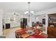 Dining area featuring hardwood floors, chandelier, and view to the kitchen at 179 Green Valley Rd, Fayetteville, GA 30214