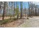 A single-story home nestled in a wooded landscape, accessed by a long driveway at 179 Green Valley Rd, Fayetteville, GA 30214