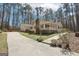 Spacious home features a long driveway, an attached garage, and a well-maintained lawn with decorative landscaping at 179 Green Valley Rd, Fayetteville, GA 30214