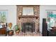 Close-up of the brick fireplace featuring a decorative mirror and accents at 179 Green Valley Rd, Fayetteville, GA 30214
