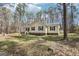 Lovely single-story home with a covered front porch, set amidst a serene wooded backdrop and lush green lawn at 179 Green Valley Rd, Fayetteville, GA 30214