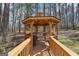 Outdoor gazebo featuring wood railings, a grill, and hanging flower pots at 179 Green Valley Rd, Fayetteville, GA 30214
