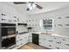 Bright kitchen features white cabinets, stainless steel appliances, and a large window with a nature view at 179 Green Valley Rd, Fayetteville, GA 30214