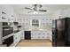 Bright kitchen features white cabinets, stainless steel appliances, and a large window with a nature view at 179 Green Valley Rd, Fayetteville, GA 30214