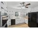 Bright kitchen features white cabinets, stainless steel appliances, and a large window with a nature view at 179 Green Valley Rd, Fayetteville, GA 30214
