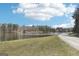 Serene lake surrounded by lush trees and greenery, bordering a dirt road at 179 Green Valley Rd, Fayetteville, GA 30214