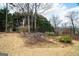 Landscaped backyard with black metal fence and mature trees at 90 Oak Walk, Villa Rica, GA 30180