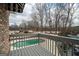 Serene backyard view featuring a sparkling pool, surrounded by mature trees at 90 Oak Walk, Villa Rica, GA 30180