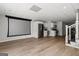 Open basement area with a projection screen, kitchenette and staircase to main floor at 90 Oak Walk, Villa Rica, GA 30180