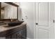 Bathroom featuring a dark brown vanity, granite countertop, and glass vessel sink at 90 Oak Walk, Villa Rica, GA 30180