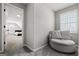 Neutral sitting area is adjacent to the bedroom, with neutral-toned walls and carpet flooring at 90 Oak Walk, Villa Rica, GA 30180