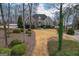 Brick home featuring lush landscaping and a winding driveway with mature trees at 90 Oak Walk, Villa Rica, GA 30180