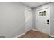 Hallway featuring hardwood floors and white doors. One is an exterior door at 90 Oak Walk, Villa Rica, GA 30180