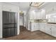 Elegant kitchen featuring stainless steel refrigerator, white cabinets, and backsplash at 90 Oak Walk, Villa Rica, GA 30180