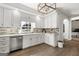 Well-lit kitchen with stylish backsplash, stainless steel dishwasher, and ample cabinet space at 90 Oak Walk, Villa Rica, GA 30180