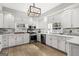 Modern kitchen featuring stainless steel appliances, quartz countertops, and custom cabinets at 90 Oak Walk, Villa Rica, GA 30180