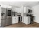 Basement kitchenette has stainless steel appliances, white cabinets, and countertop at 90 Oak Walk, Villa Rica, GA 30180