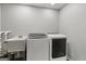 Bright laundry room featuring modern washer and dryer, plus a utility sink for added convenience at 90 Oak Walk, Villa Rica, GA 30180