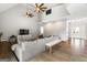Bright living room with a stone fireplace, high ceilings, and two ceiling fans at 90 Oak Walk, Villa Rica, GA 30180