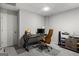 Basement home office with modern desk, chair, monitor and cabinets for storage at 90 Oak Walk, Villa Rica, GA 30180