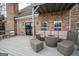 Spacious outdoor deck featuring a seating area with wicker furniture and an outdoor fireplace at 90 Oak Walk, Villa Rica, GA 30180