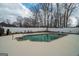 Sparkling backyard swimming pool with a concrete patio and mature trees at 90 Oak Walk, Villa Rica, GA 30180