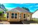 Close-up of the home's rear exterior, featuring a small patio and clean landscaping detail at 136 Glynn Addy Dr, Stockbridge, GA 30281