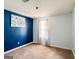 Sunlit bedroom with a light carpet, accent wall, and decorative painting at 136 Glynn Addy Dr, Stockbridge, GA 30281