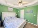 This bedroom features a tray ceiling, ceiling fan and large window at 136 Glynn Addy Dr, Stockbridge, GA 30281