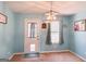 Charming dining room with modern lighting and a view of the backyard through the window at 136 Glynn Addy Dr, Stockbridge, GA 30281