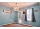 Cozy dining area featuring modern light fixture, accent wall color and door to the outside at 136 Glynn Addy Dr, Stockbridge, GA 30281