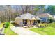 Aerial view of a cozy single-story home featuring a manicured lawn and driveway at 136 Glynn Addy Dr, Stockbridge, GA 30281