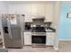 Bright kitchen featuring stainless steel appliances, white cabinetry, and modern backsplash at 136 Glynn Addy Dr, Stockbridge, GA 30281