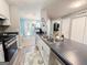 Kitchen view with stainless steel appliances, white cabinets and breakfast bar; laundry room to the right at 136 Glynn Addy Dr, Stockbridge, GA 30281