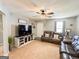 Cozy living room featuring neutral walls, a large TV, and comfortable leather seating at 136 Glynn Addy Dr, Stockbridge, GA 30281