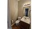 Cozy half bathroom featuring a vanity sink and toilet at 741 S Fairfield Dr, Peachtree City, GA 30269