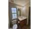 Cozy bathroom with vanity sink, toilet and window at 741 S Fairfield Dr, Peachtree City, GA 30269