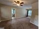 Bedroom features carpeted floors, a ceiling fan, and a small bathroom at 741 S Fairfield Dr, Peachtree City, GA 30269