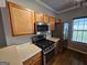 Well-lit kitchen features stainless steel appliances and wooden cabinets at 741 S Fairfield Dr, Peachtree City, GA 30269