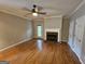 Spacious living room with hardwood floors, fireplace and a ceiling fan at 741 S Fairfield Dr, Peachtree City, GA 30269